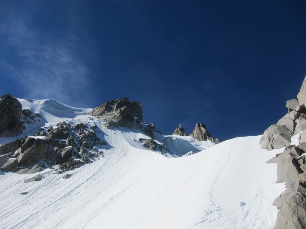 Looking up at the snow arete for the end of the rock, and the bivi ledges.